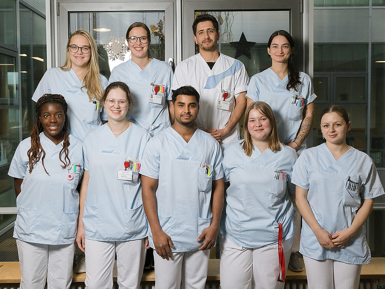 Ausbildungsstart an der Berufsfachschule Agatharied Gruppenfoto von neun neuen Auszubildenden der Berufsfachschule Agatharied in hellblauen Kasacks, die lächelnd in einem hellen Flur stehen.Gruppenfoto von neun neuen Auszubildenden der Berufsfachschule Agatharied in hellblauen Kasacks, die lächelnd in einem hellen Flur stehen.